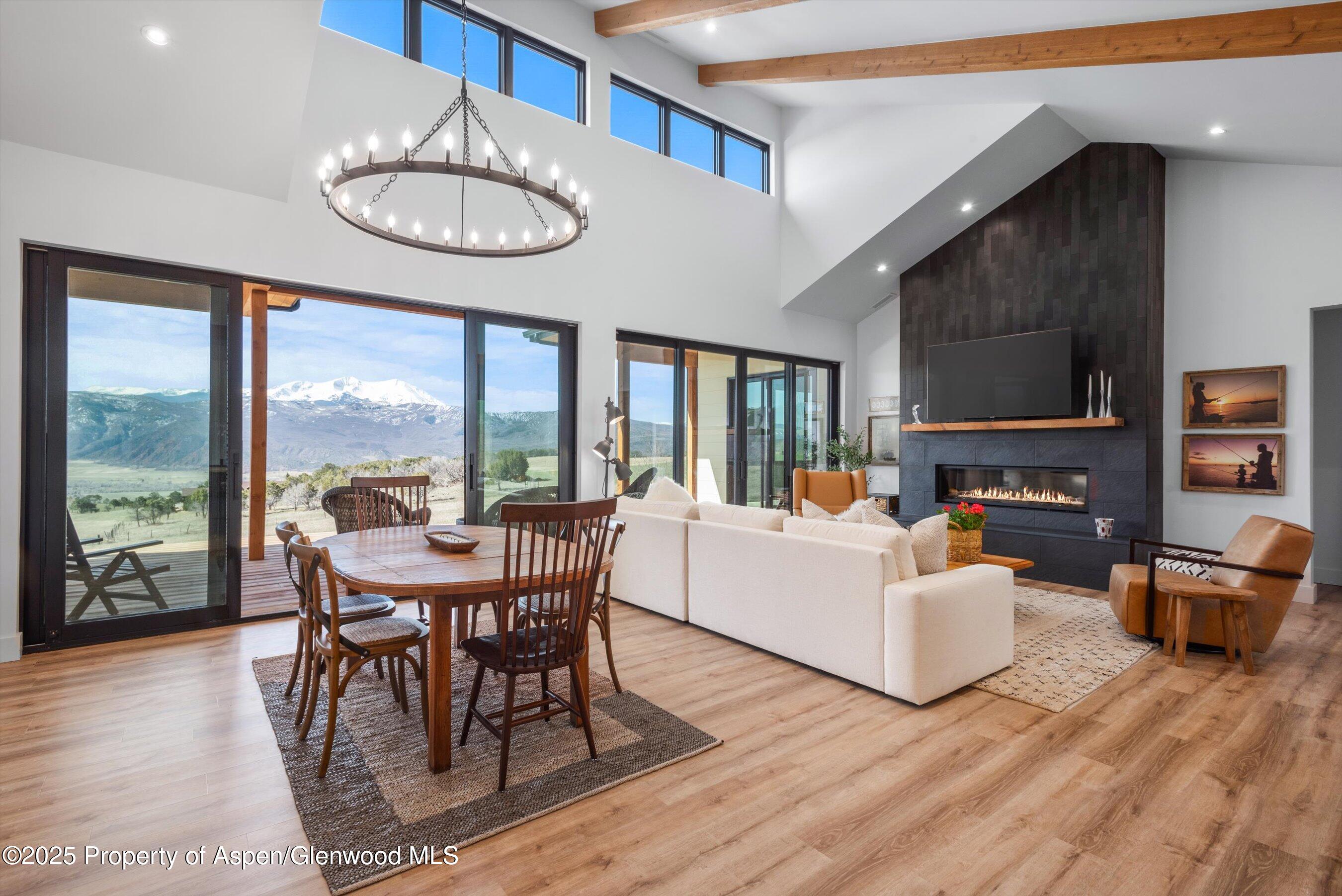 1840 Upper Cattle Creek Road Carbondale, CO 81623 - Photo 12 of 37 a view of a dining room with furniture wooden floor and chandelier