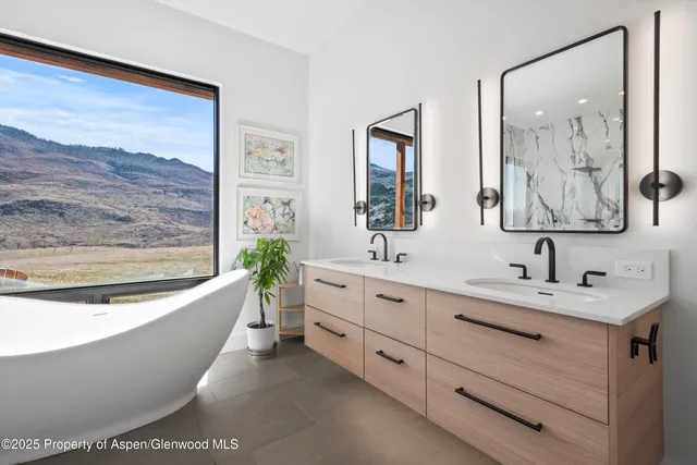 a bathroom with a bathtub a sink and a mirror