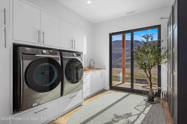 a view of a storage & utility room with a sink