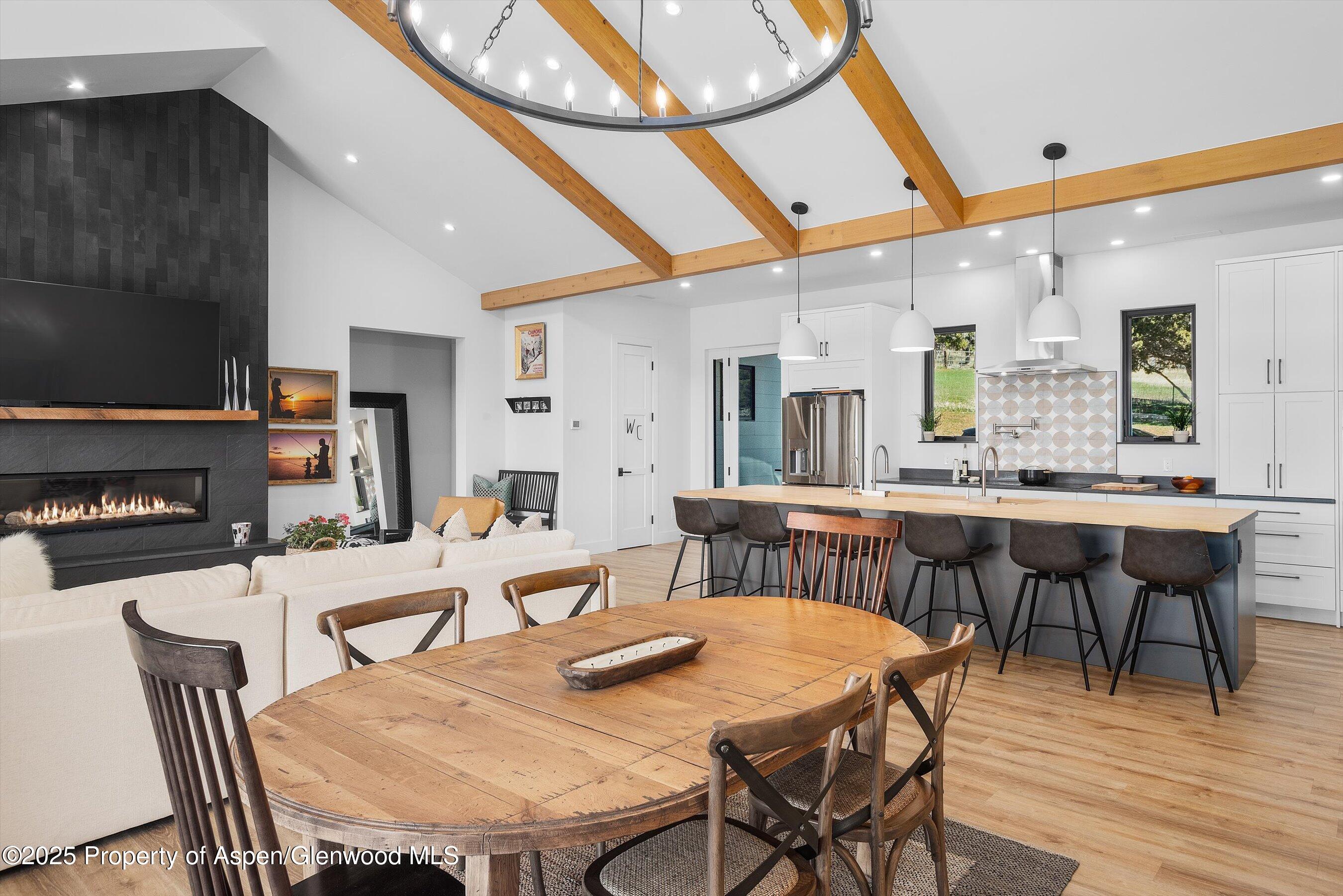 1840 Upper Cattle Creek Road Carbondale, CO 81623 - Photo 8 of 37 a view of a dining room with furniture and wooden floor