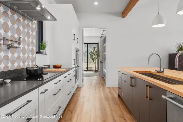 a kitchen with granite countertop a sink and cabinets