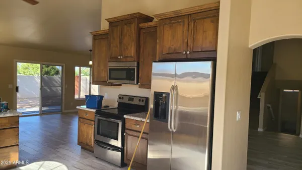 a spacious bathroom with a granite countertop sink a mirror and vanity