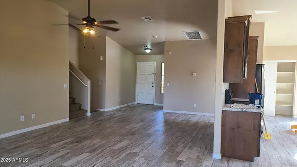 a kitchen with granite countertop a refrigerator and a stove top oven