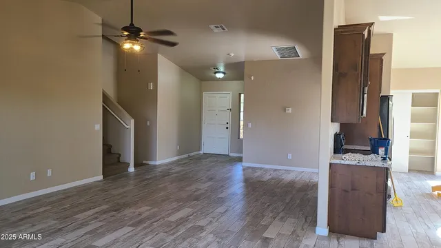a kitchen with granite countertop a refrigerator and a stove top oven