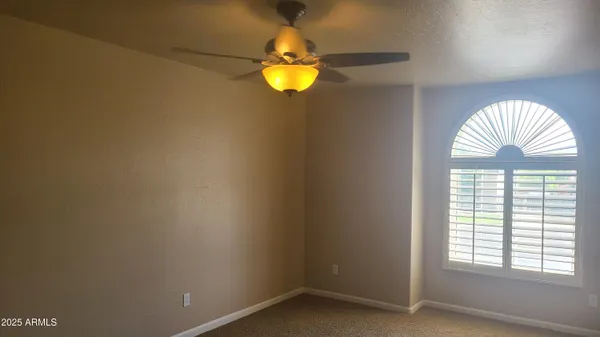 a kitchen with stainless steel appliances granite countertop a refrigerator a sink dishwasher a stove and a dining table with wooden floor