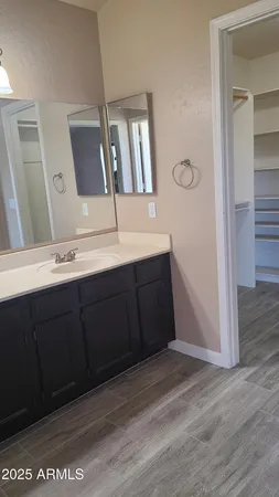 a view of walk in closet with empty racks