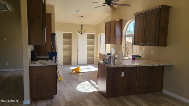 a view of a room with wooden floor and window