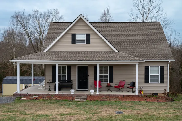 a front view of a house with yard and outdoor seating