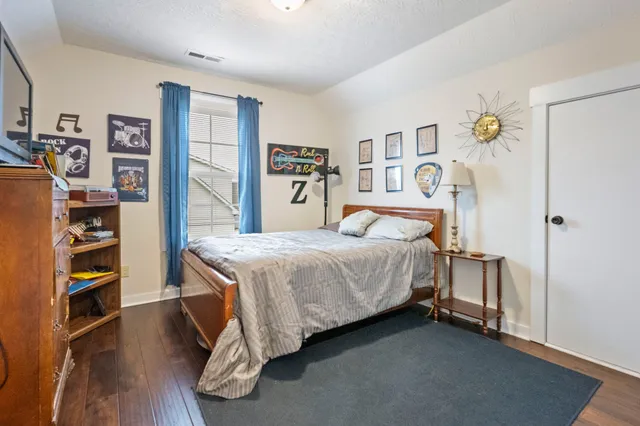a bedroom with a bed and a book shelf