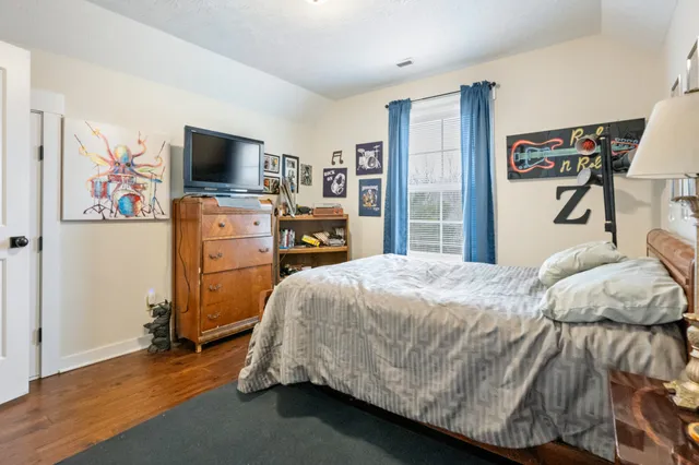 a bedroom with a bed and a flat screen tv