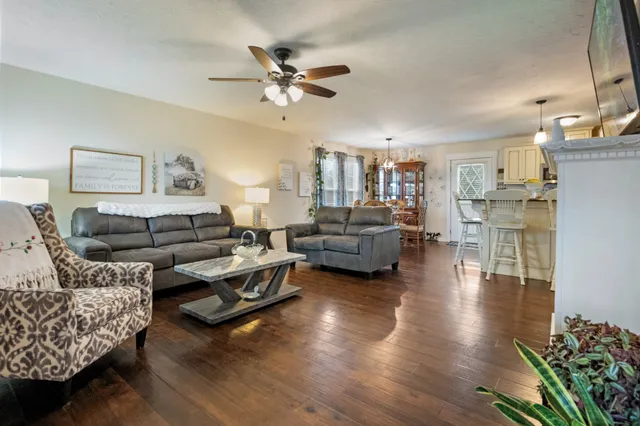 a living room with furniture and a chandelier