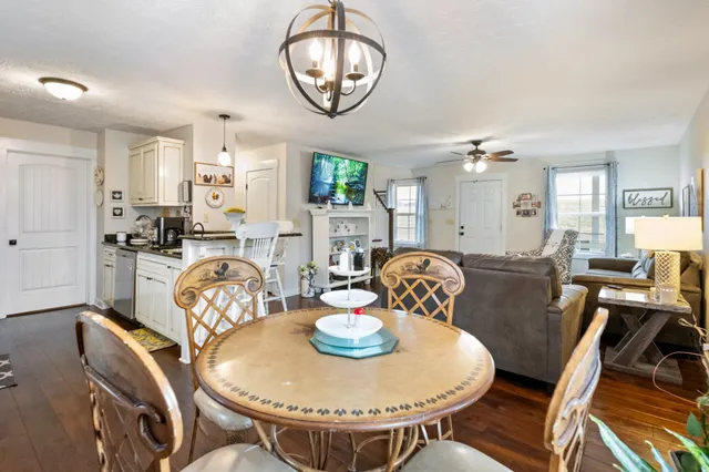 a view of a dining room with furniture a chandelier and wooden floor