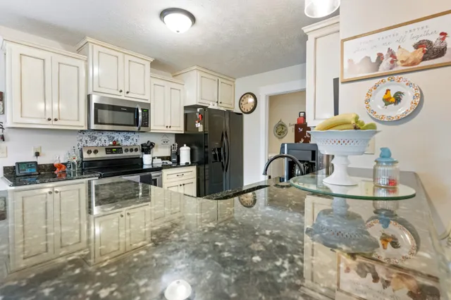 a kitchen with stainless steel appliances granite countertop a stove and a sink