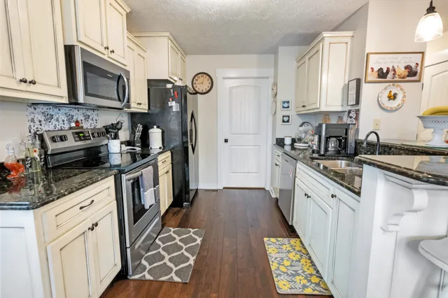 a kitchen with stainless steel appliances granite countertop a stove and a sink