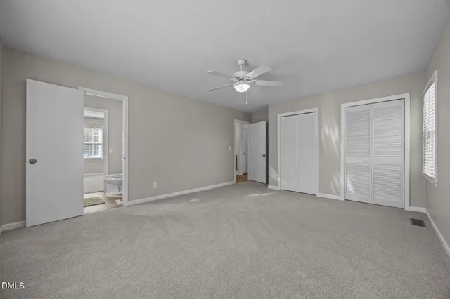 an empty room with a empty space and windows