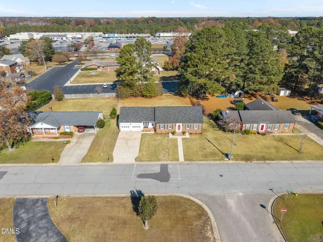 an aerial view of a house with a swimming pool