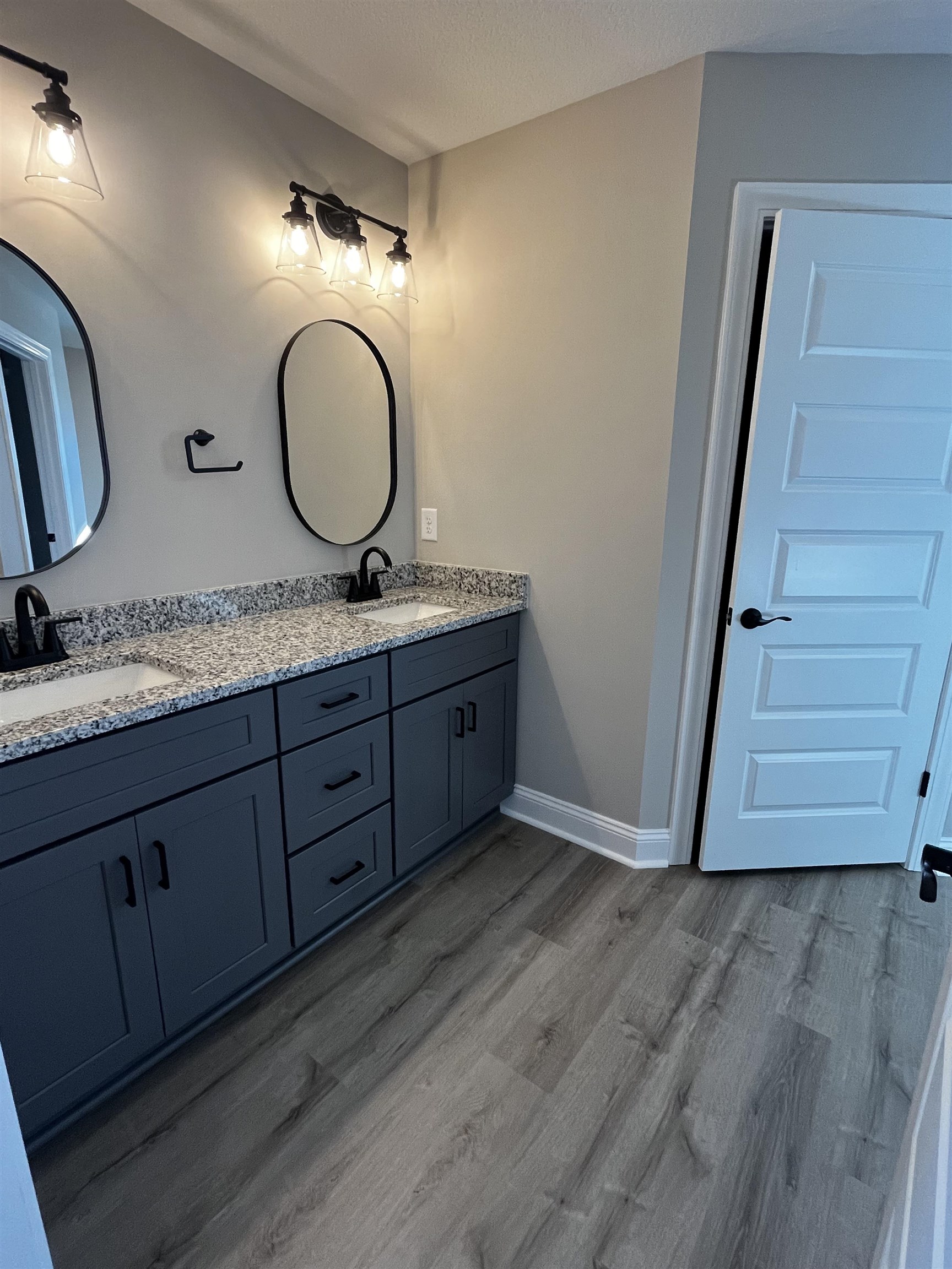 3436 Asbury Road Aynor, SC 29511 - Photo 6 of 9 Full bathroom featuring double vanity, dark wood-style floors, and a textured ceiling