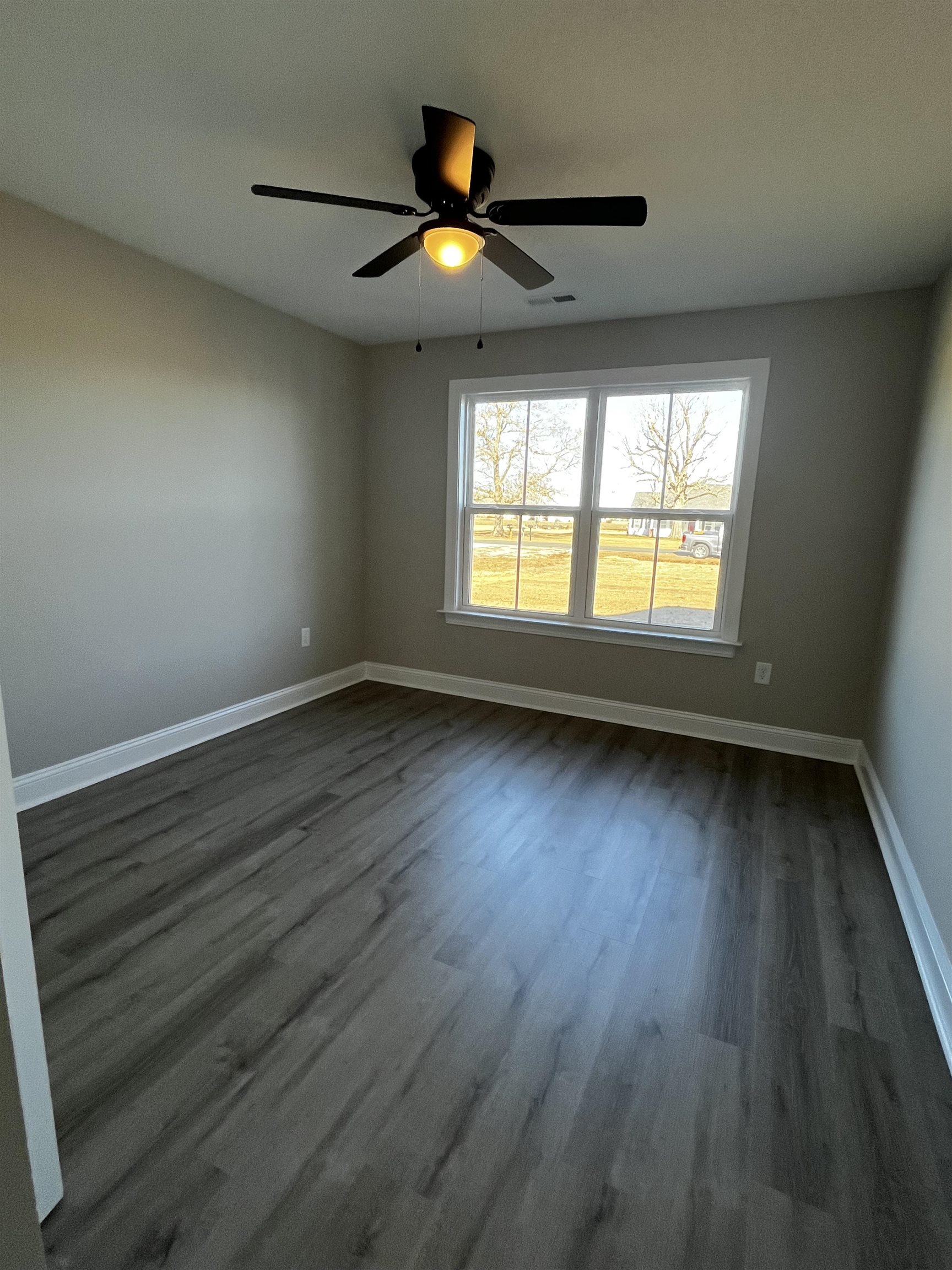 3436 Asbury Road Aynor, SC 29511 - Photo 7 of 9 Empty room with dark wood-style floors and ceiling fan
