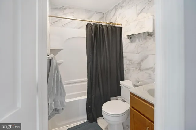 a bathroom with a shower and a toilet