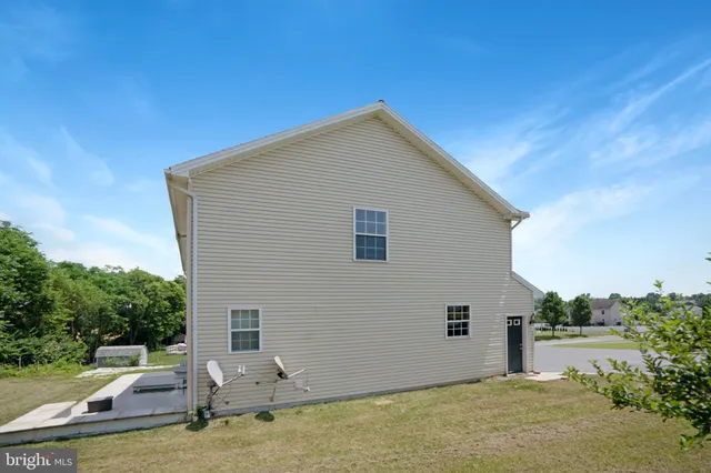 a backyard of a house with yard and outdoor seating