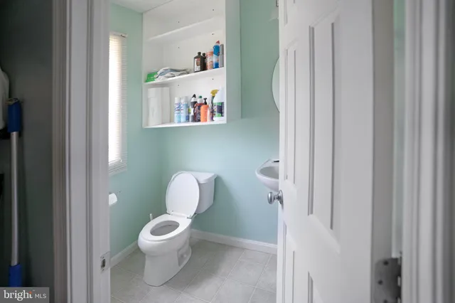 a white toilet sitting next to a bathroom sink