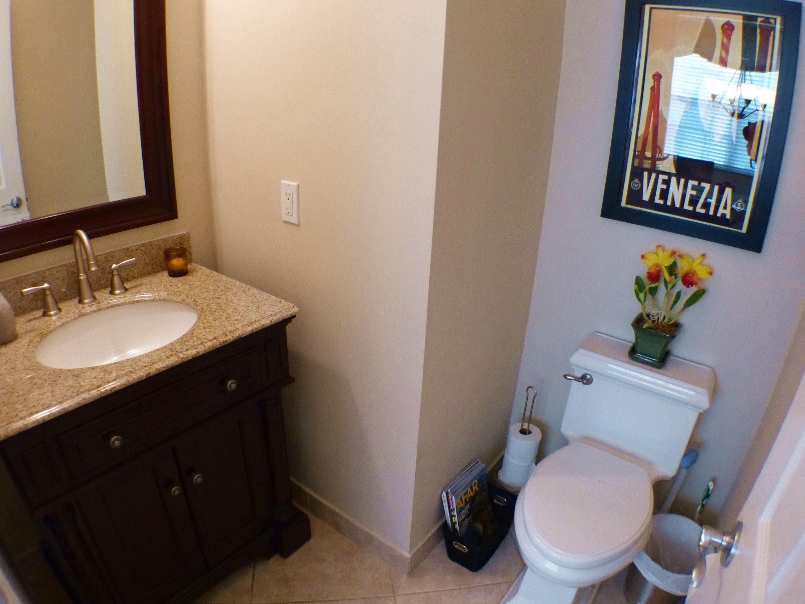 1826 Northwest 9th Street Boca Raton, FL 33431 - Photo 12 of 22 a bathroom with a toilet sink vanity and mirror