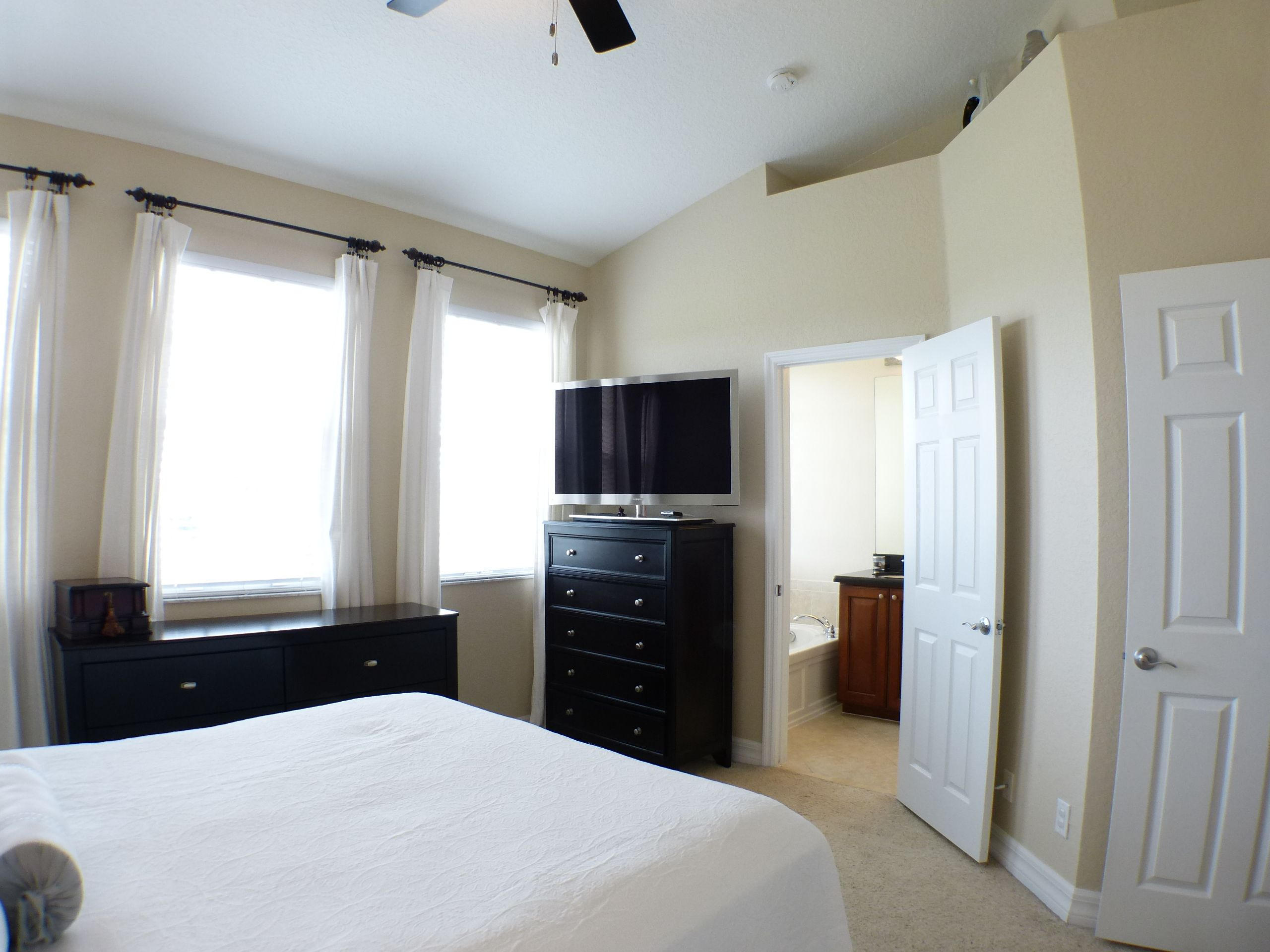 1826 Northwest 9th Street Boca Raton, FL 33431 - Photo 15 of 22 a bedroom with a bed and a flat tv screen