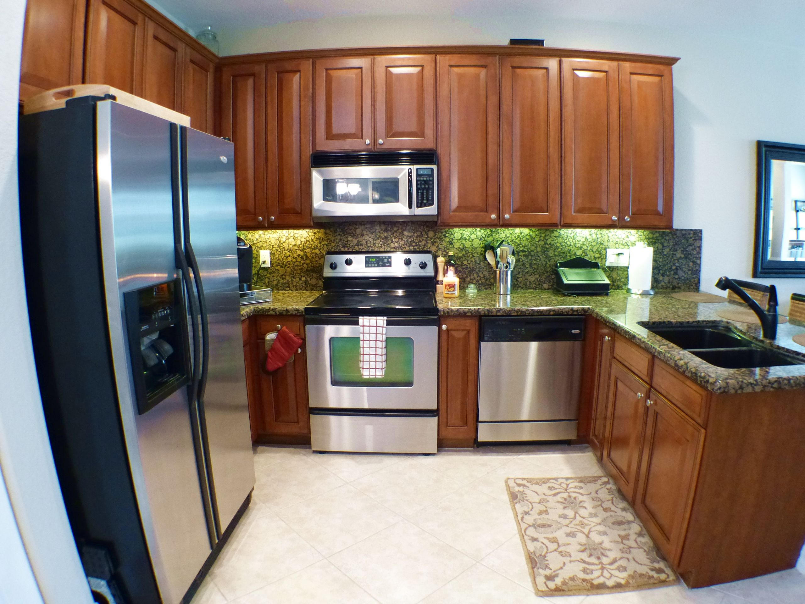 1826 Northwest 9th Street Boca Raton, FL 33431 - Photo 9 of 22 a kitchen with stainless steel appliances granite countertop a refrigerator a stove a sink and dishwasher