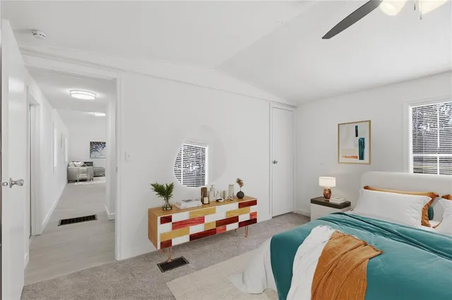 a roof deck with couches and wooden fence