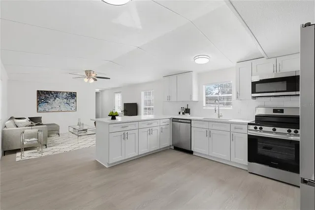 a spacious bathroom with a double vanity sink a mirror and a window