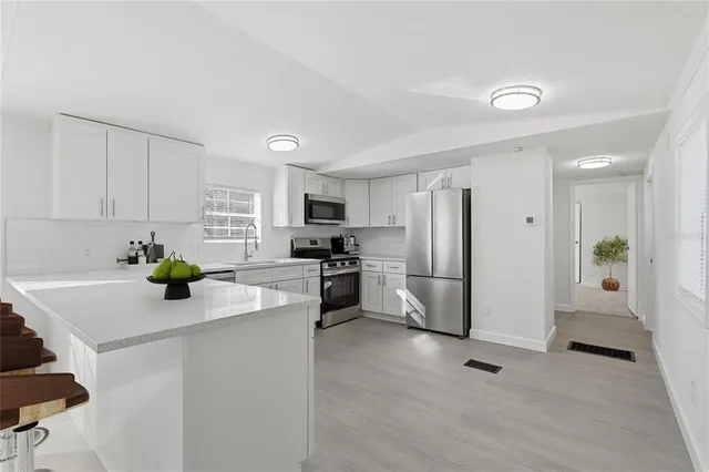a kitchen with a refrigerator and a sink