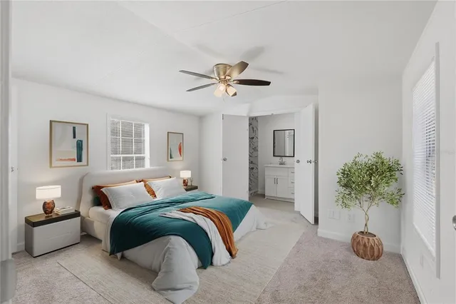 a spacious bedroom with a bed and a chandelier