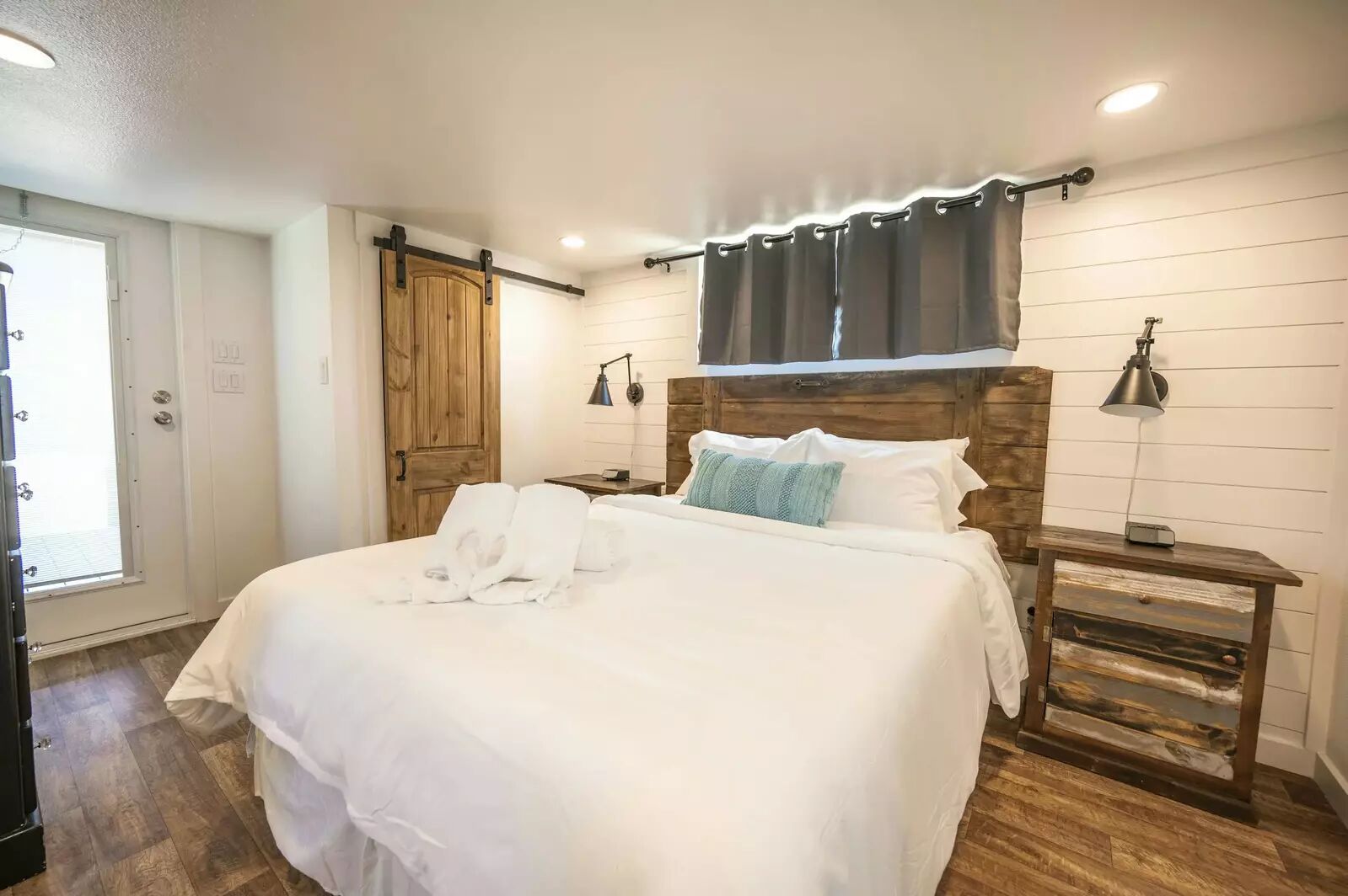 5386 Ranch Road 1376, Unit 79 Fredericksburg, TX 78624 - Photo 11 of 39 Bedroom with a barn door, dark wood finished floors, and recessed lighting