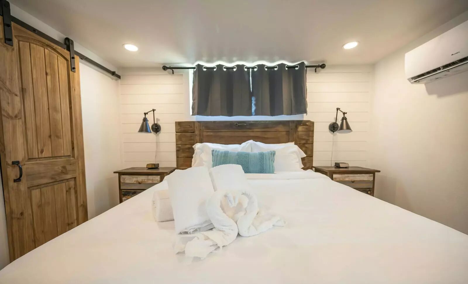 5386 Ranch Road 1376, Unit 79 Fredericksburg, TX 78624 - Photo 12 of 39 Bedroom with a barn door, a mini split for heating / cooling, and recessed lighting