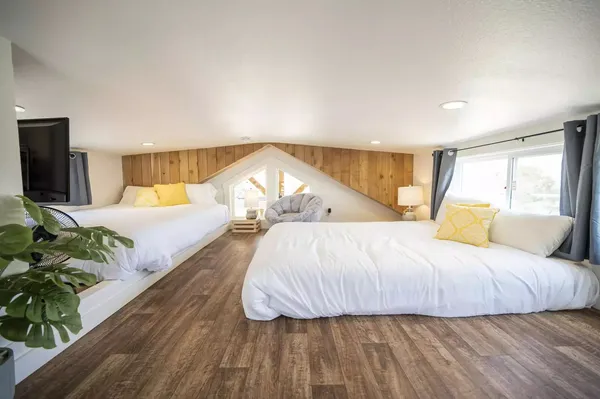 a spacious bedroom with a bed and a large window