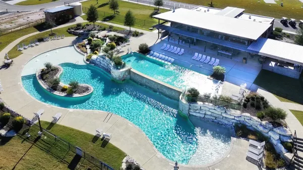 a view of swimming pool with outdoor seating space