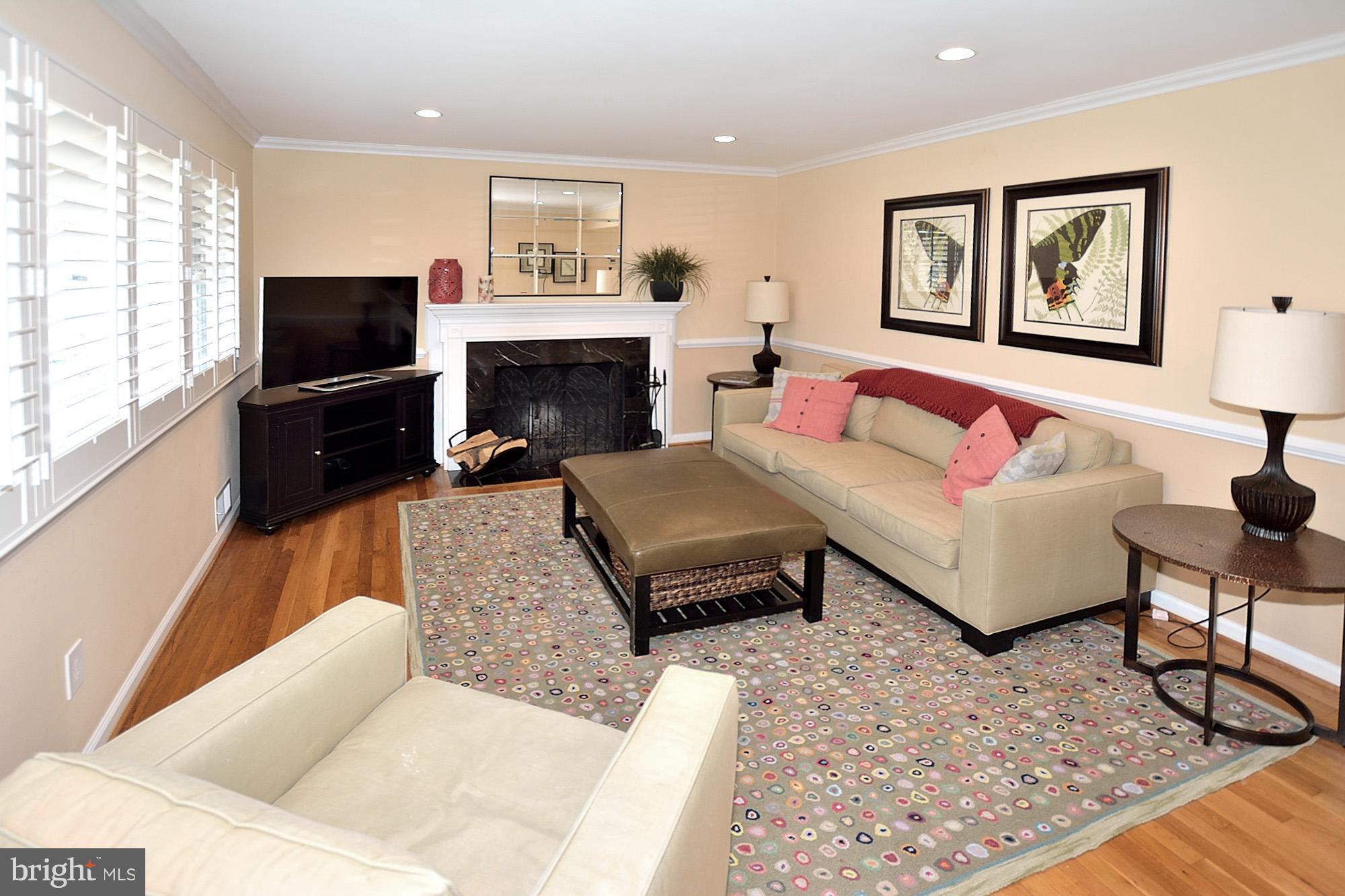 506 Tapawingo Road Southwest Vienna, VA 22180 - Photo 2 of 25 a living room with furniture and a flat screen tv