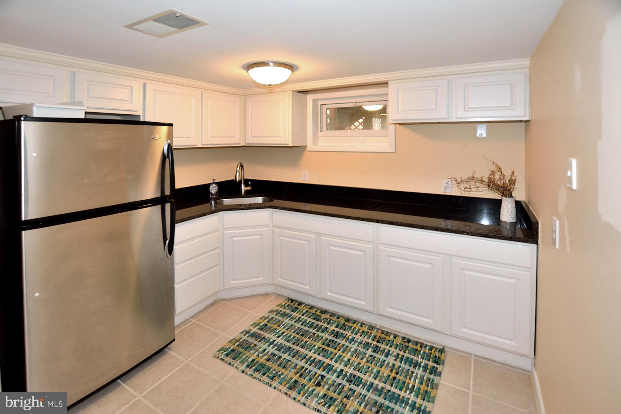 506 Tapawingo Road Southwest Vienna, VA 22180 - Photo 19 of 25 a kitchen with a refrigerator and cabinets
