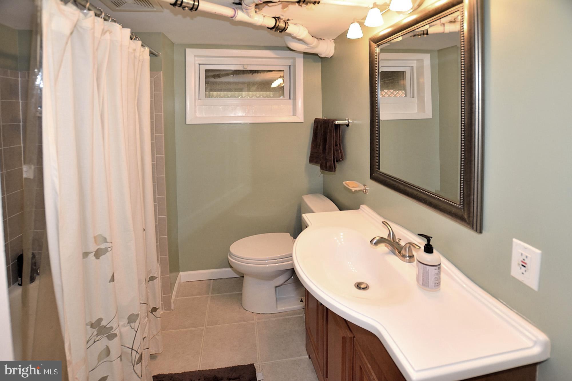 506 Tapawingo Road Southwest Vienna, VA 22180 - Photo 20 of 25 a bathroom with a sink vanity mirror and toilet