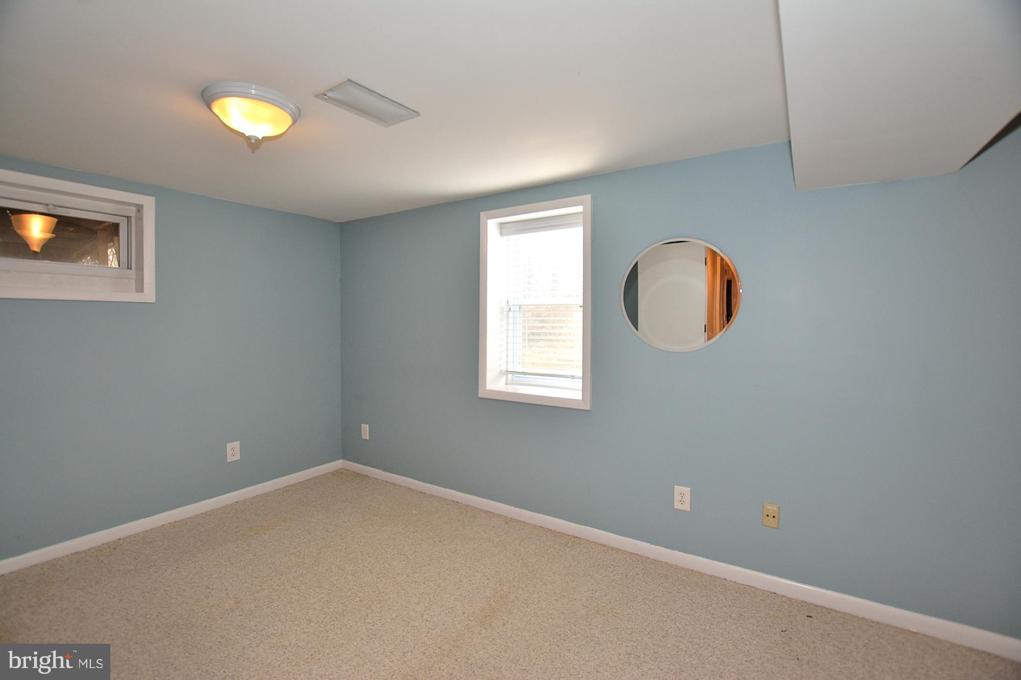 506 Tapawingo Road Southwest Vienna, VA 22180 - Photo 22 of 25 a view of an empty room with window and wooden floor