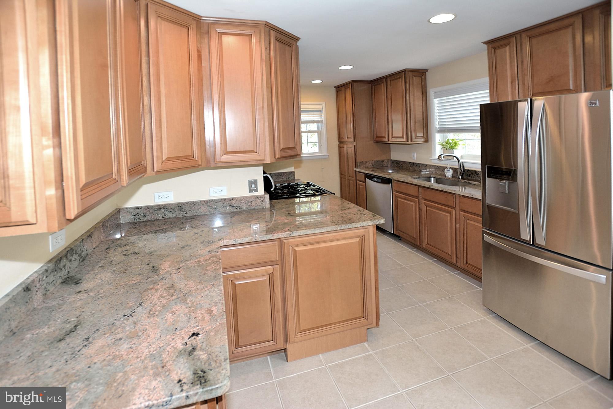 506 Tapawingo Road Southwest Vienna, VA 22180 - Photo 7 of 25 a kitchen with stainless steel appliances granite countertop a refrigerator sink and cabinets