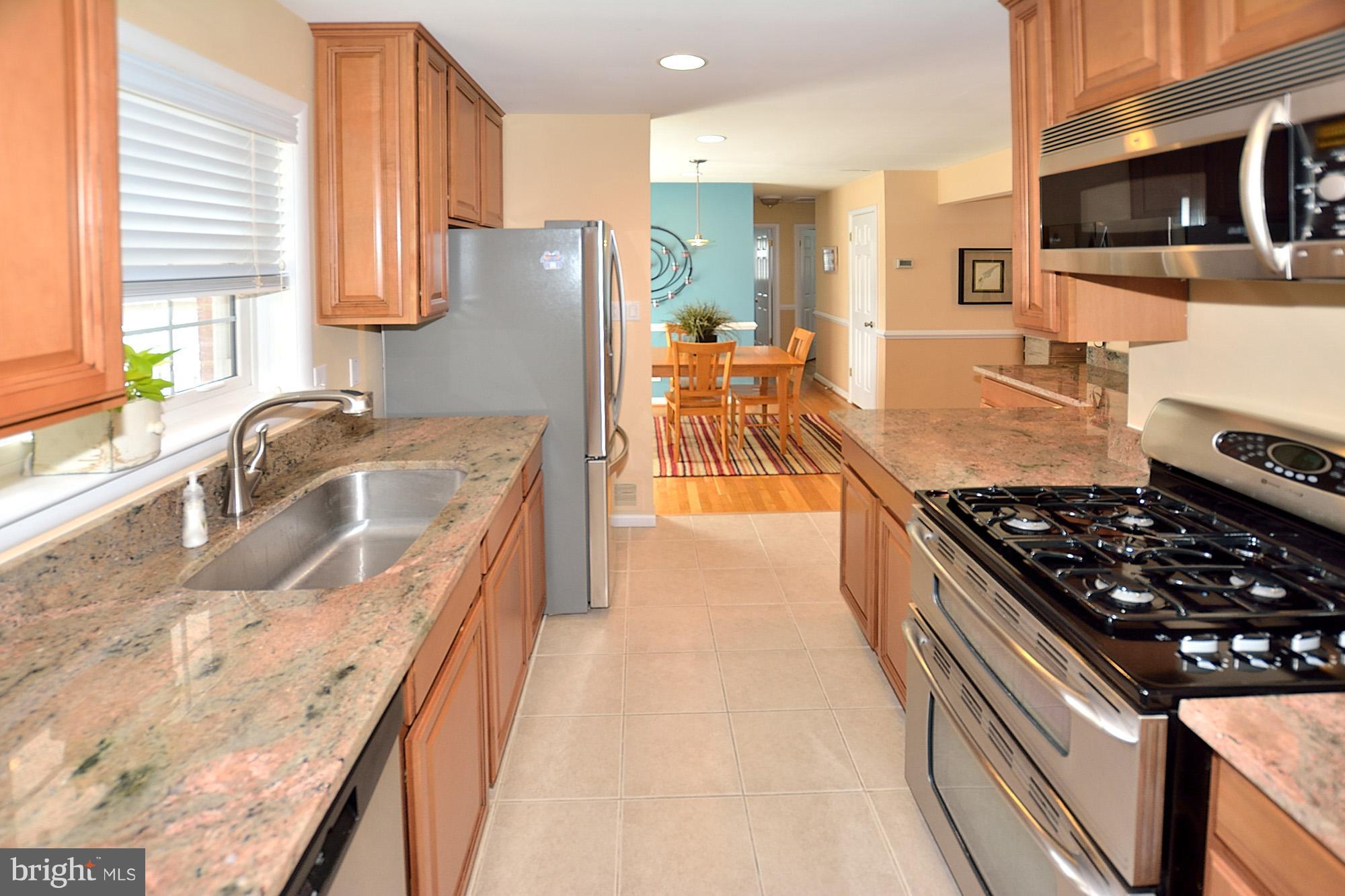 506 Tapawingo Road Southwest Vienna, VA 22180 - Photo 10 of 25 a kitchen with granite countertop a stove and a sink