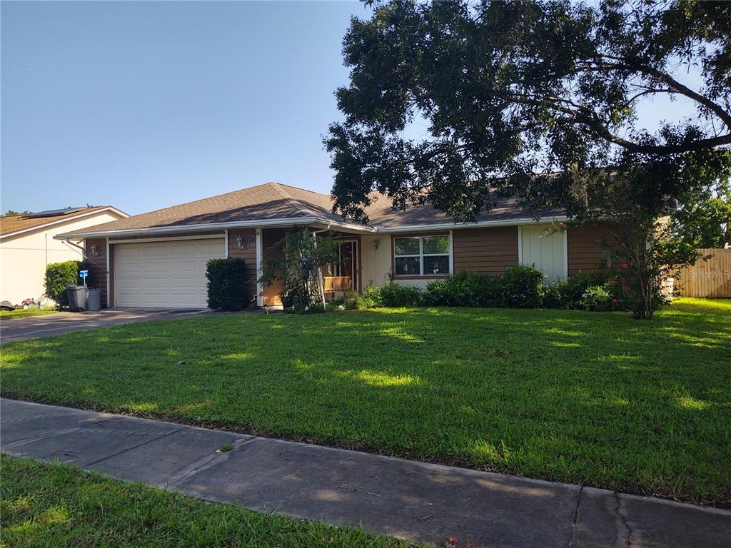 7841 Lightfoot Drive New Port Richey, FL 34653 - Photo 1 of 1 a front view of a house with a garden