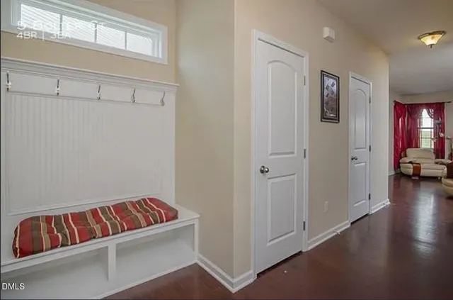 a living room with furniture and a book shelf