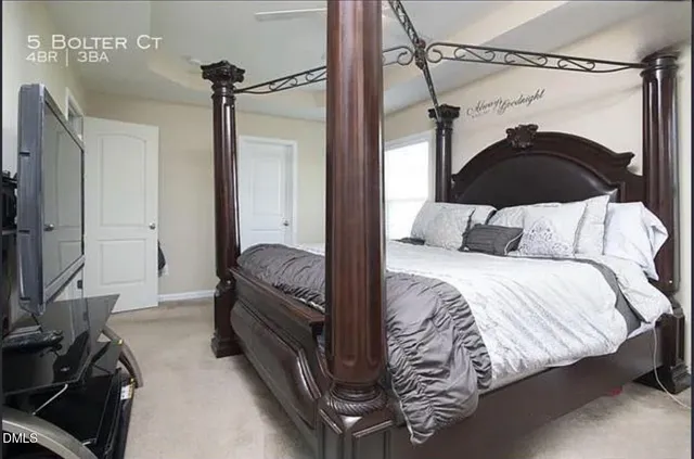 a bedroom with a bed and a mirror