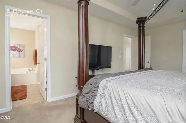 a bedroom with a bed and a mirror