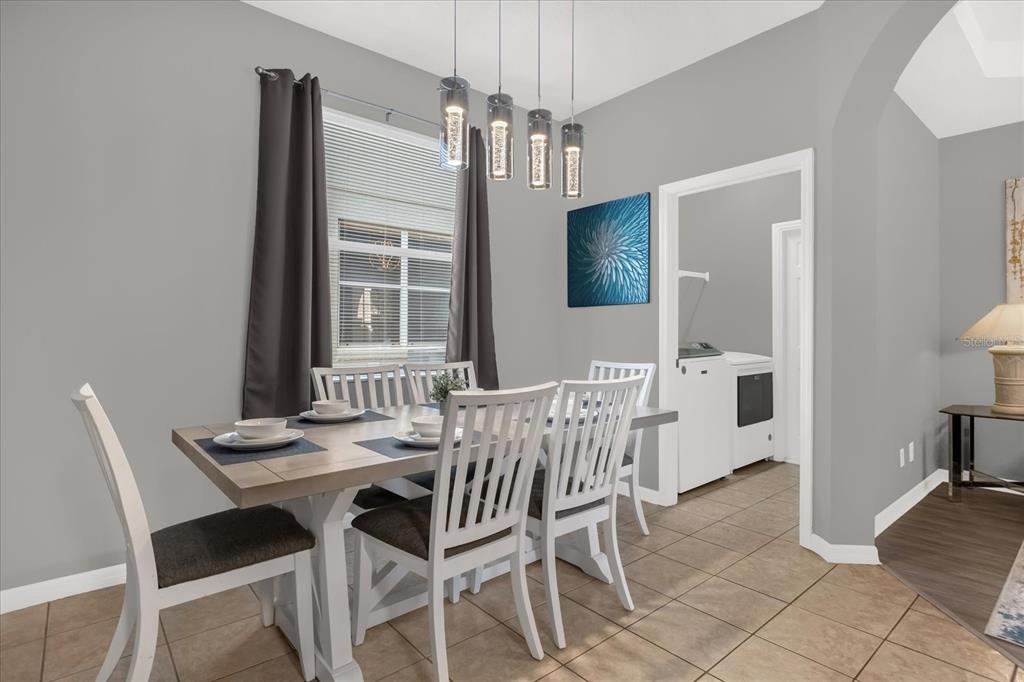 246 Montara Drive Davenport, FL 33897 - Photo 11 of 37 a view of a dining room with furniture and window