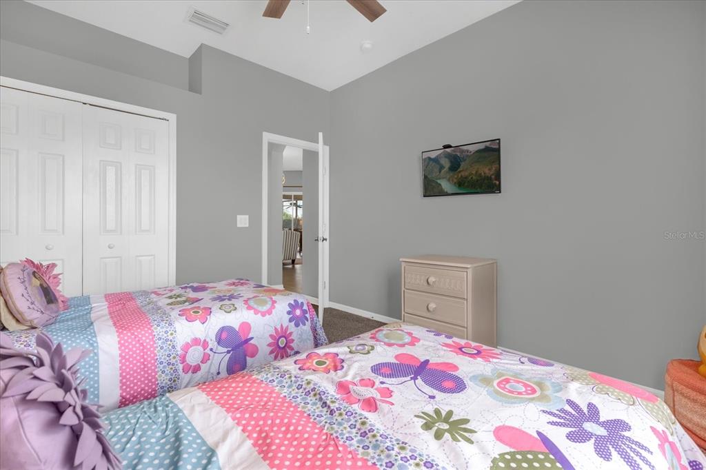 246 Montara Drive Davenport, FL 33897 - Photo 15 of 37 a bedroom with a bed and a lamp