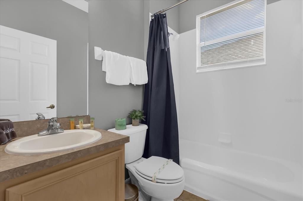 246 Montara Drive Davenport, FL 33897 - Photo 16 of 37 a bathroom with a toilet sink and mirror