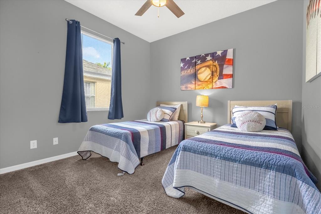 246 Montara Drive Davenport, FL 33897 - Photo 17 of 37 a bedroom with two beds and a window